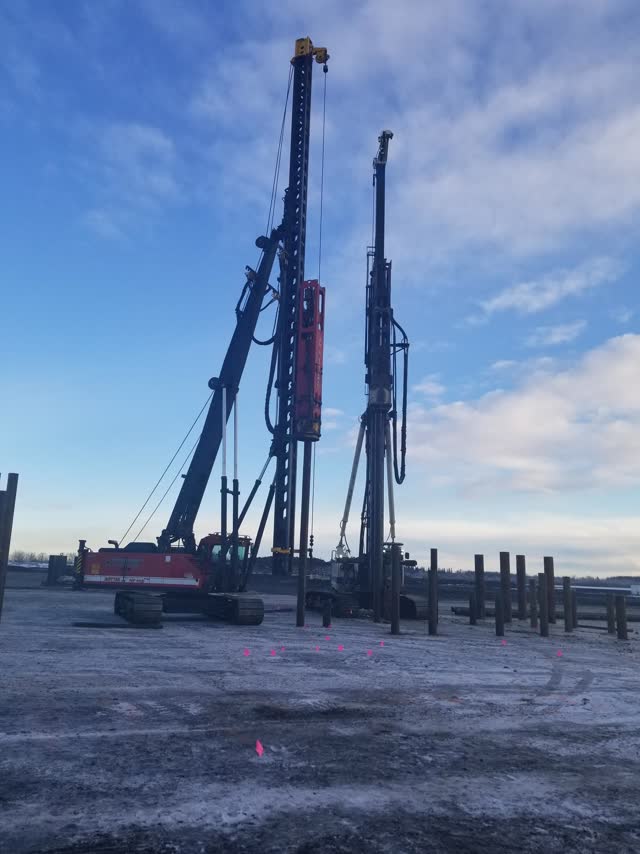 Two lattice pile rigs working a foundation spread