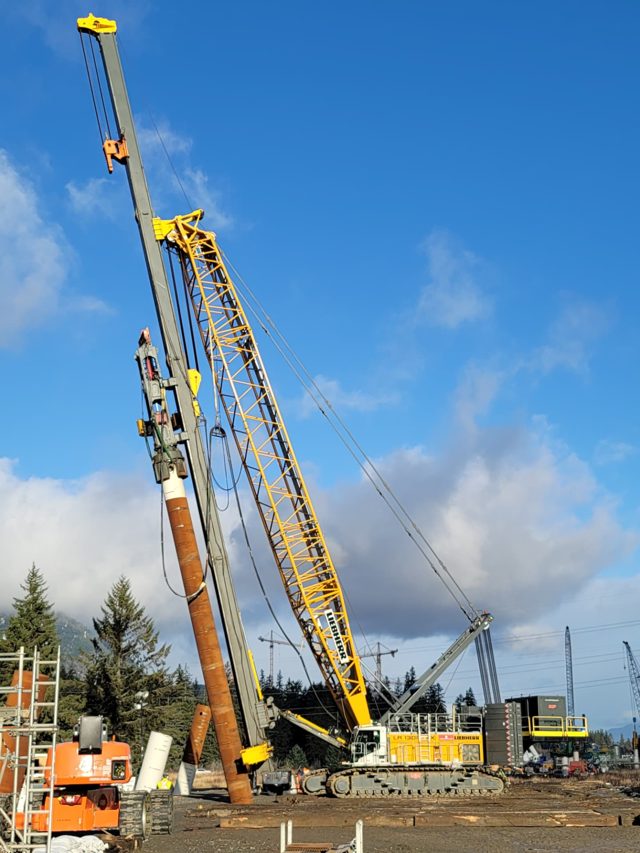 Battered large-diameter driven pile set in crane leads