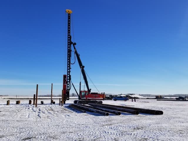 Pile driving rigs operating on a frozen winter pad