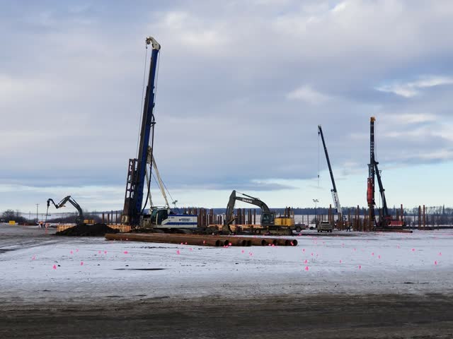 Winter pile field with multiple rigs advancing production piles