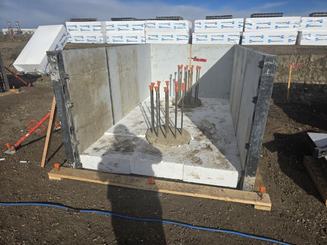 Insulated formwork and anchor-bolt cage prepared for a cold-weather pedestal pour