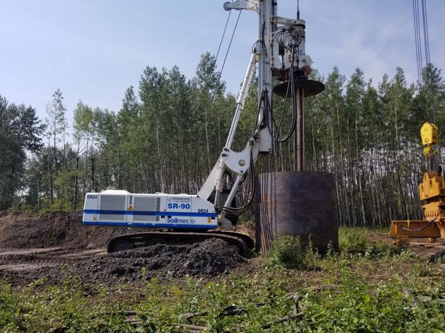 Rotary rig advancing a large-diameter cased shaft on a cleared right-of-way