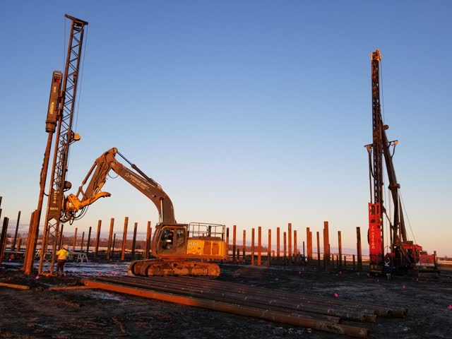 Full winter piling spread with excavators and pile leads