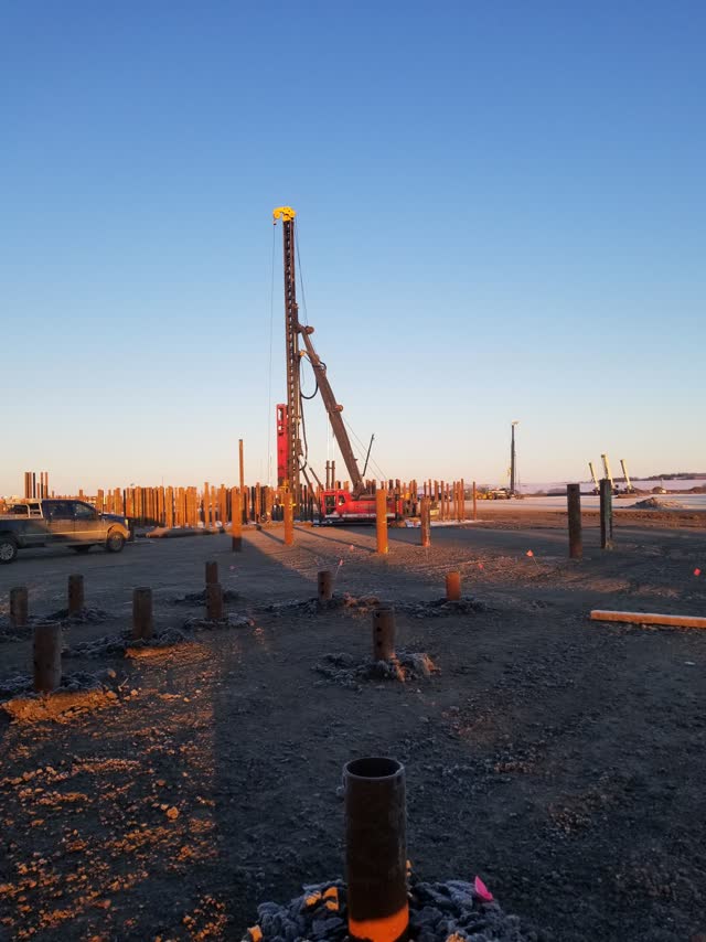 Casing installation continuing at sunset on a frozen pad