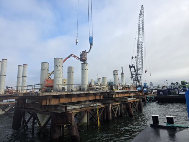 Marine trestle under construction with completed pile bents