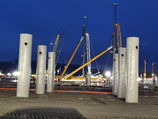 Night-shift piling operations beside completed concrete columns