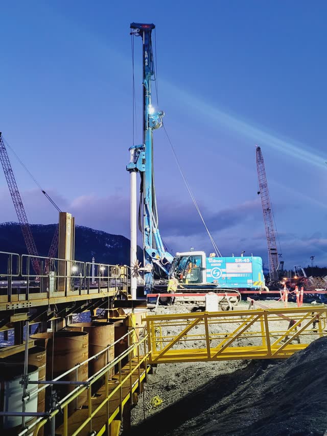 Piling rigs and access platform on a site at dusk