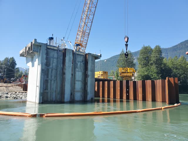Concrete pier works within a sheet-piled river enclosure